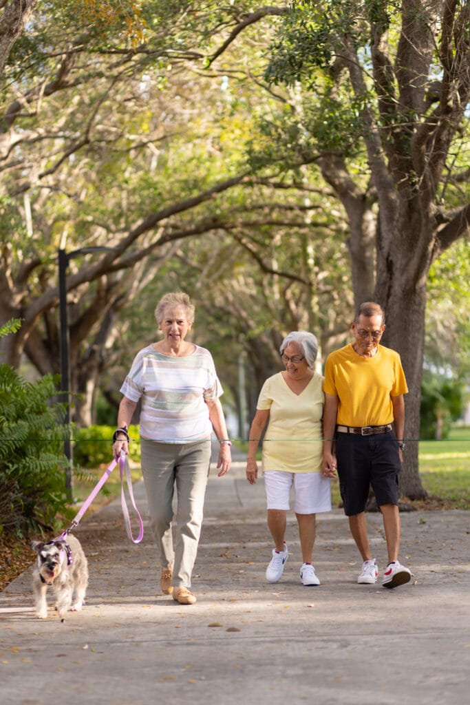 people walking a dog on east ridge grounds
