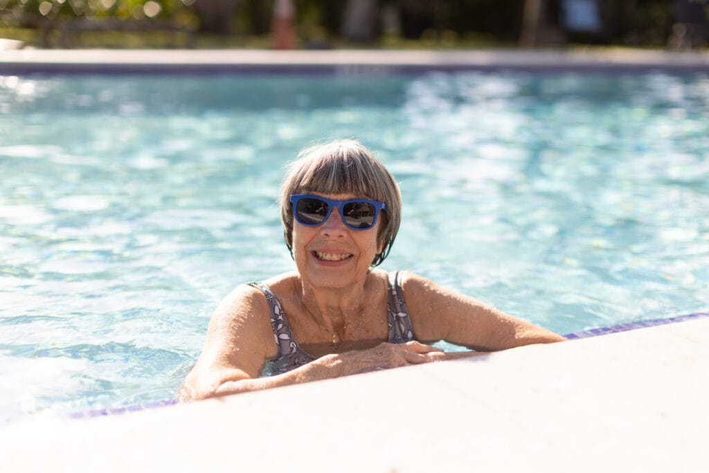 happy woman swimming in a pool in East Ridge