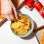 Top view of pizza, chips, and cold Coca-Cola. Ideal for fast food themes.