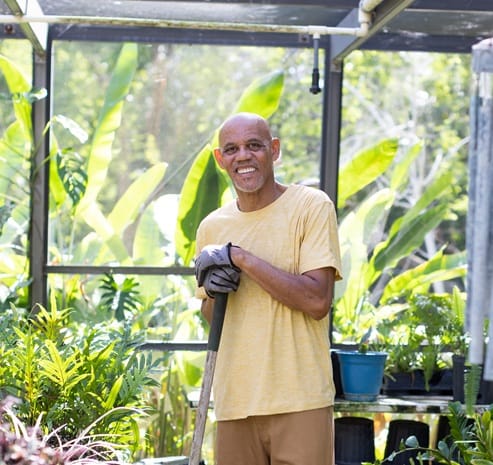 man gardening in greenhouse easrt ridge village