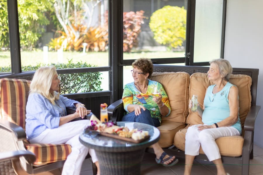 women talking in porch at east ridge village