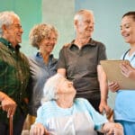 Caregiver reviewing a resident's chart with her adult children