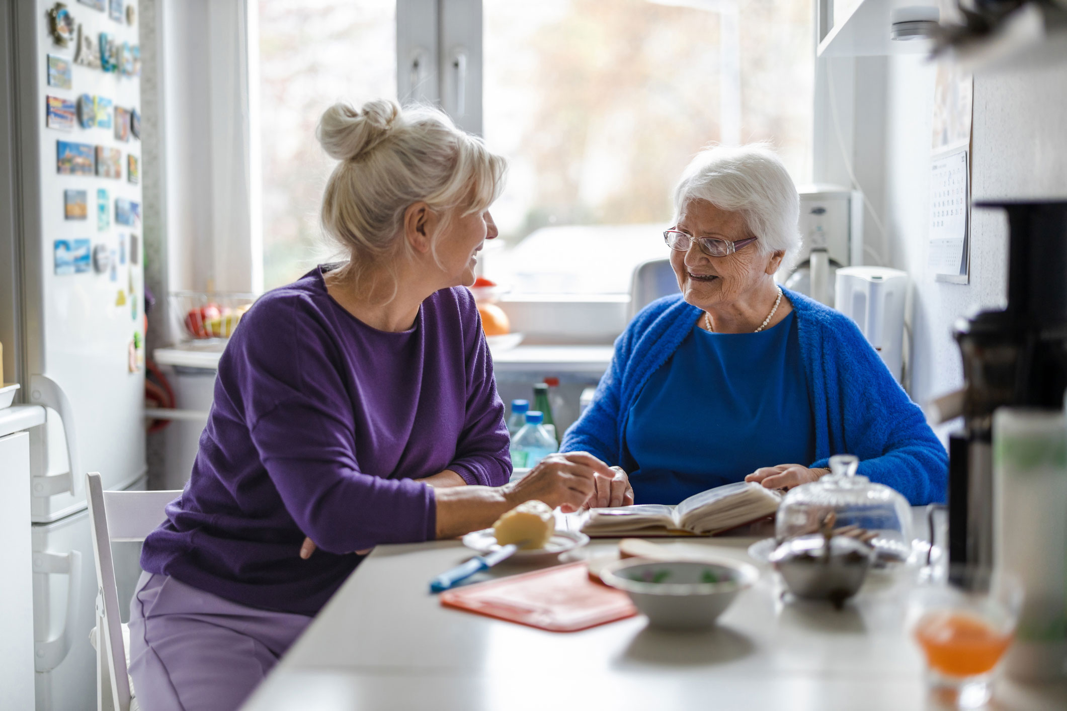 Adult child speaking with her senior mother about Assisted Living